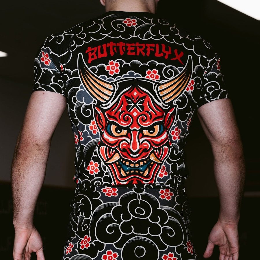 Back of the ButterflyX Oni rash guard, a red oni mask on black