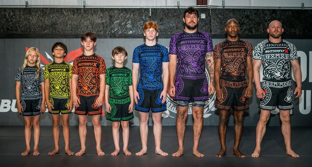 Kids and adults lined up in ButterflyX rash guards and shorts