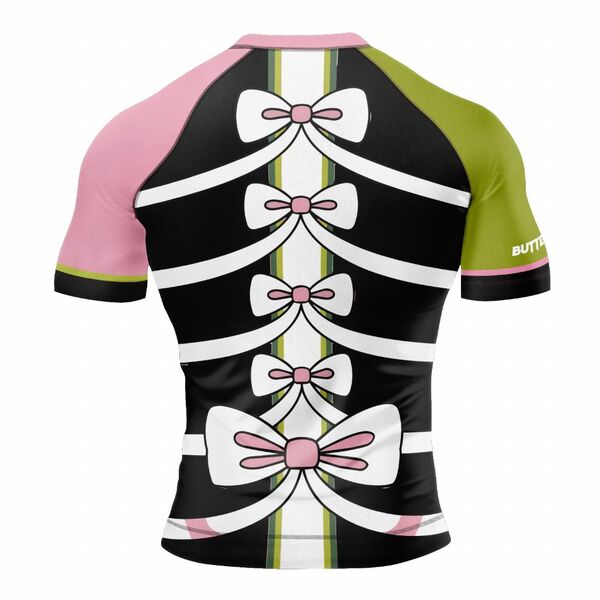 Back of a black rash guard with pink and green sleeves and white bows down the back