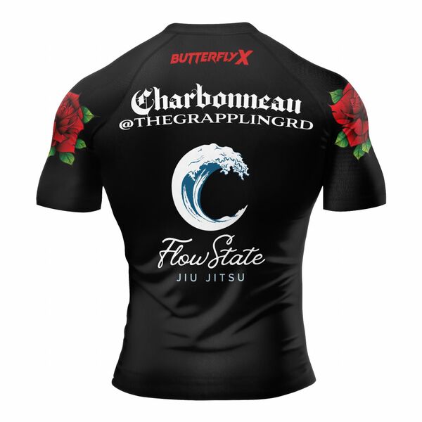Back of a black rash guard with red roses on the sleeves, the name Charbonneau and the FlowState Jiu Jitsu wave logo