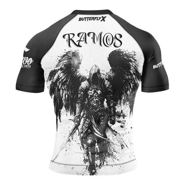 Back of a white rash guard with black sleeves, the name Ramos and an ink drawing of a winged angel