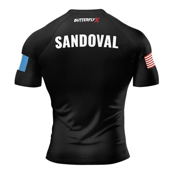 Back of a black rash guard with the name Sandoval and flag patches on the sleeves