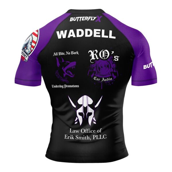 Back of a black rash guard with purple sleeves, the name Waddell and sponsor logos